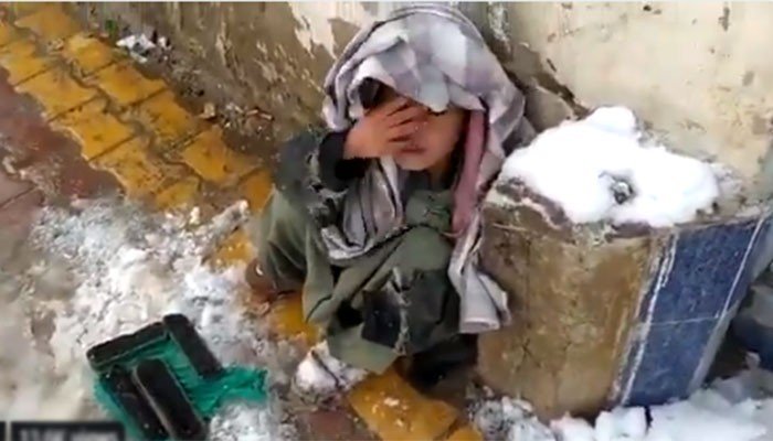 Balochistan govt takes guardianship of child shoeshiner crouching in cold weather