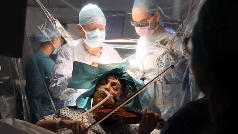 Woman plays violin during brain surgery