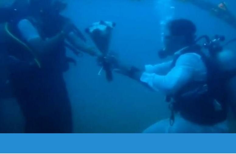 VIDEO: Couple dive 60 feet underwater to tie the knot