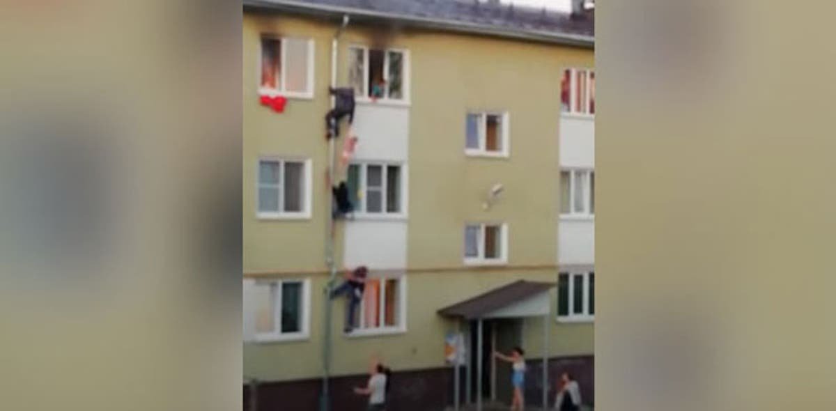VIDEO: Men climb up pipe to save kids from fire