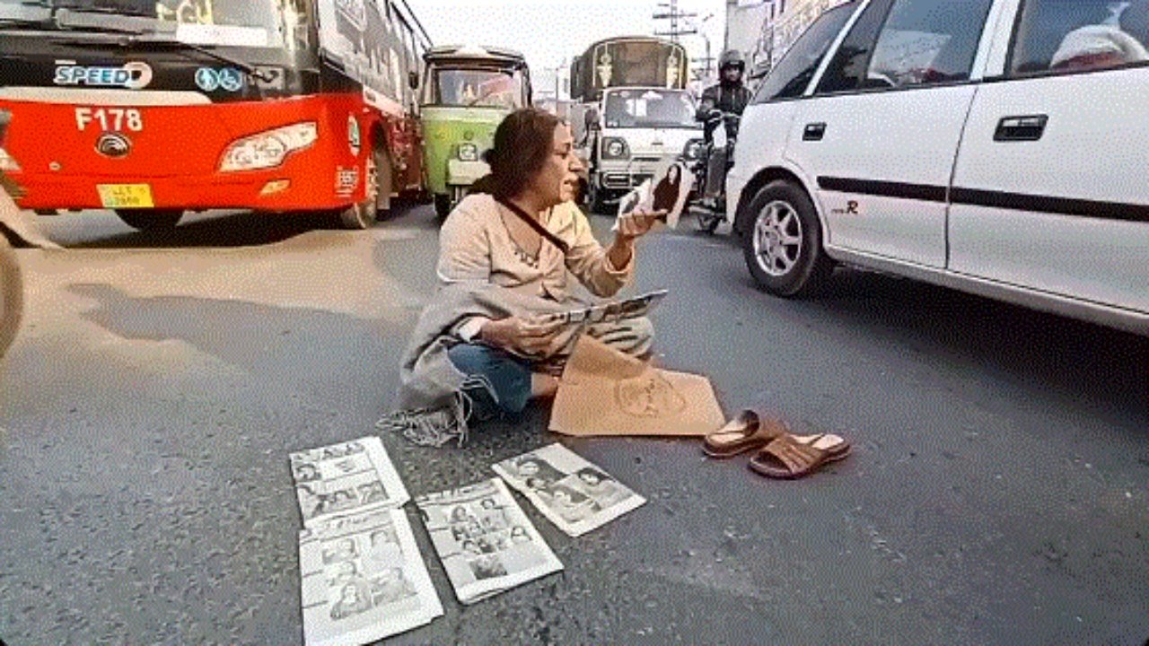 Elderly woman sits in oncoming traffic to protest the disappearance of her daughter