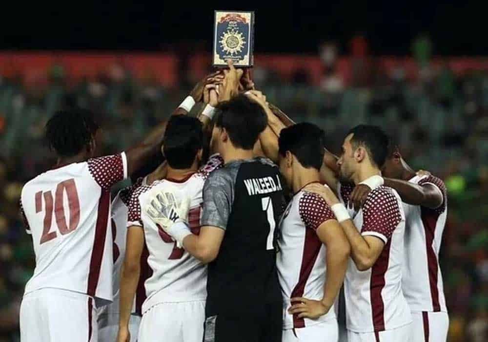 Fans and players hold up the Quran in protest against Holy Book burning incident in Sweden